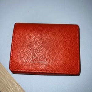 Longchamp Orange Pebbled Leather compact wallet